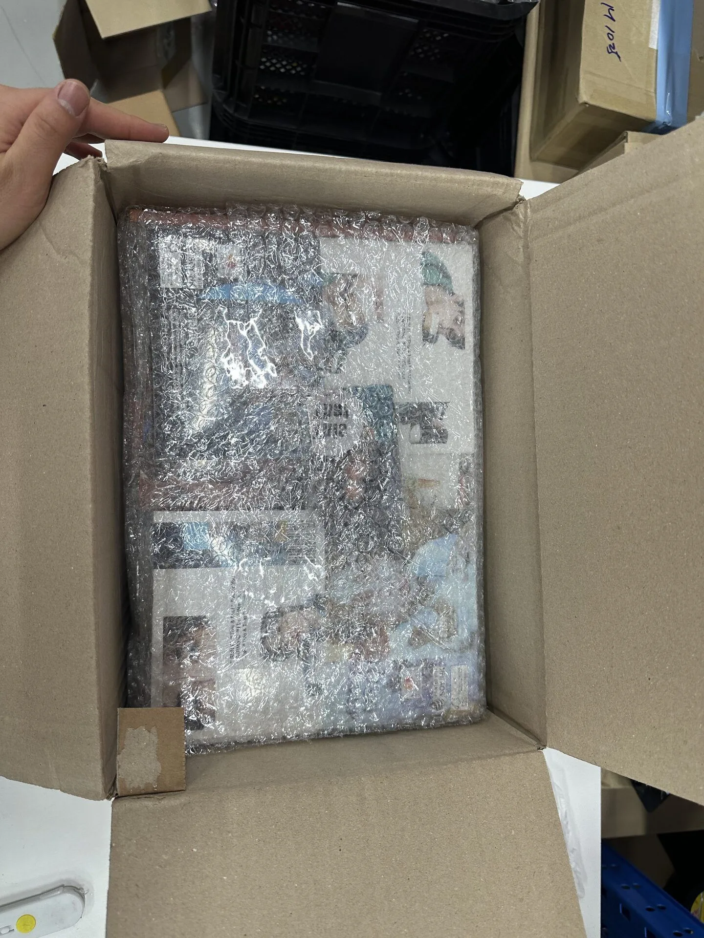 Consolidated K-pop shipment carton reinforced with blue packing tape