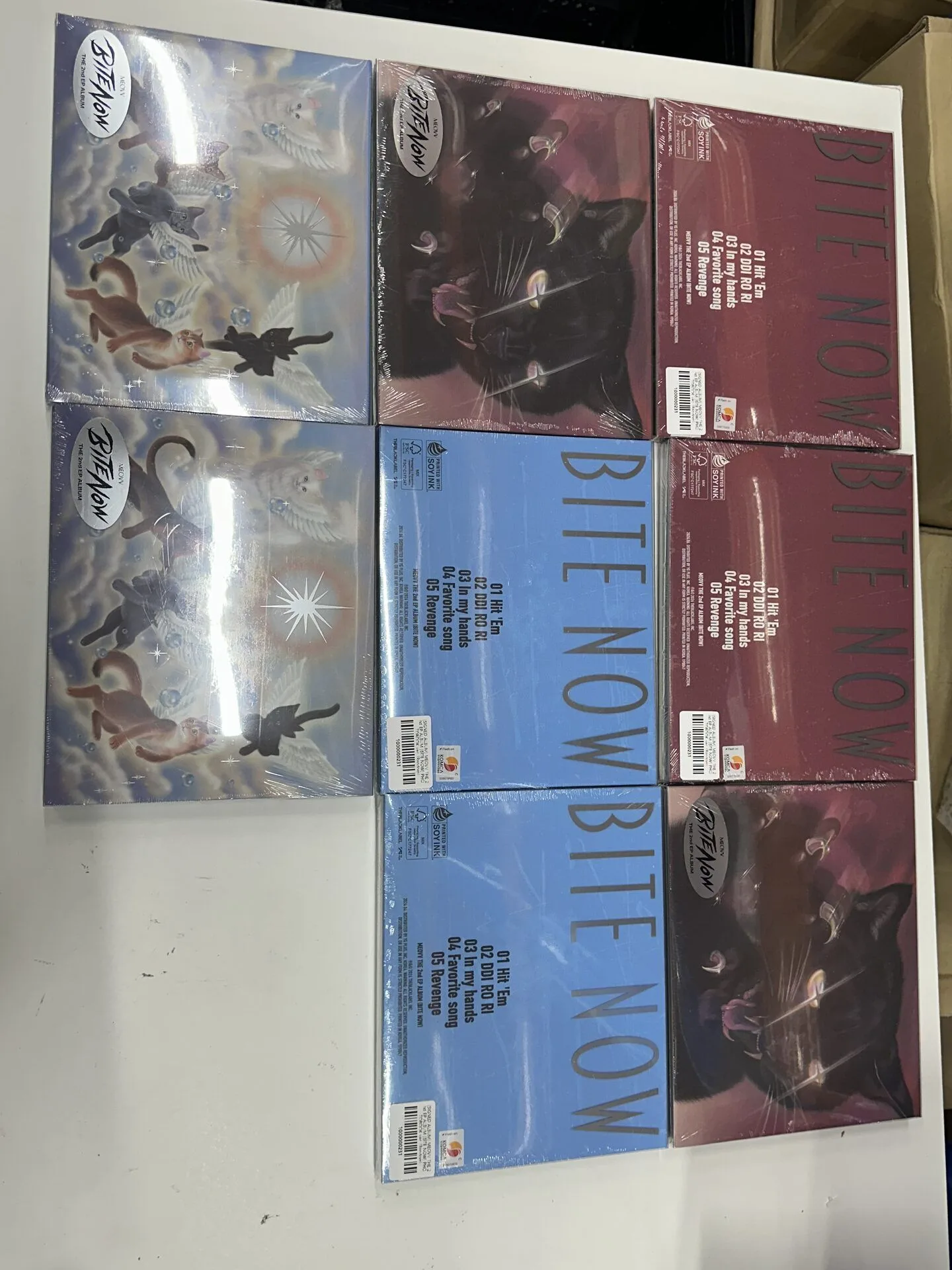 Multiple K-pop album versions arranged for a visual quantity check
