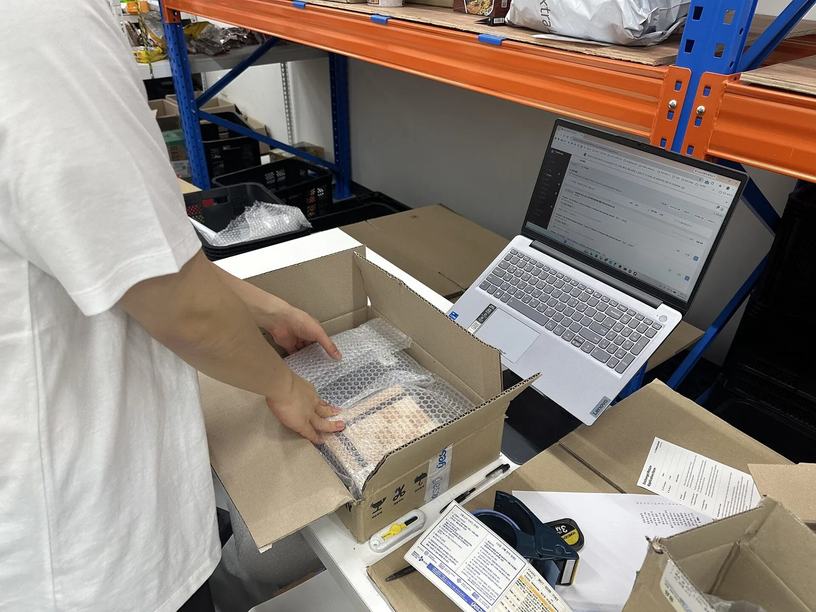 KIKIT staff checking K-pop products inside an opened seller parcel