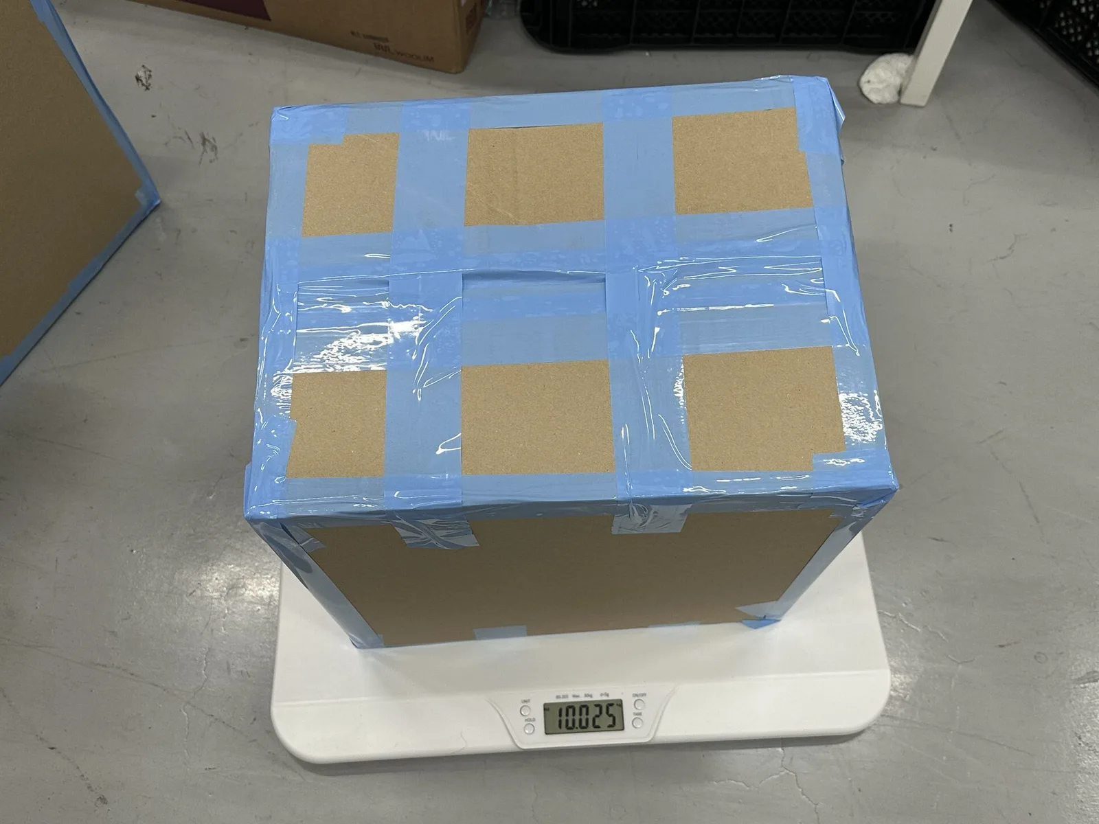 Packed K-pop export box placed on a scale for final weight recording